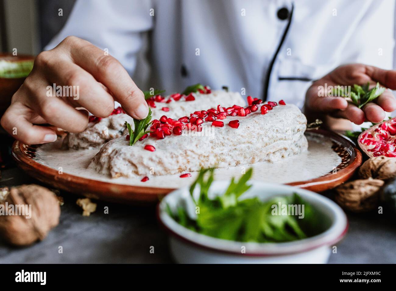 mexican woman chef cooking chiles en nogada recipe with Poblano chili ...