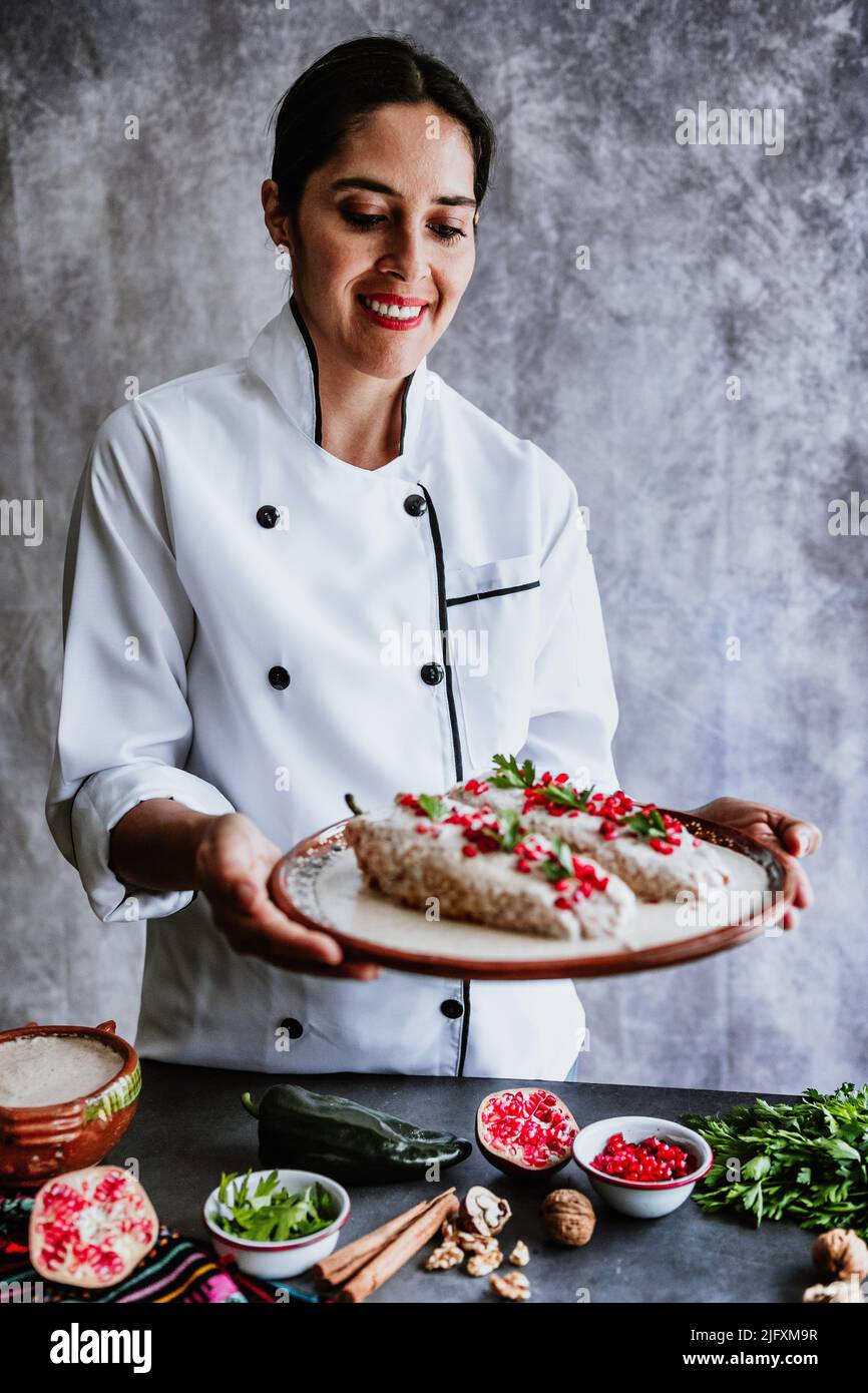 mexican woman chef cooking chiles en nogada recipe with Poblano chili ...