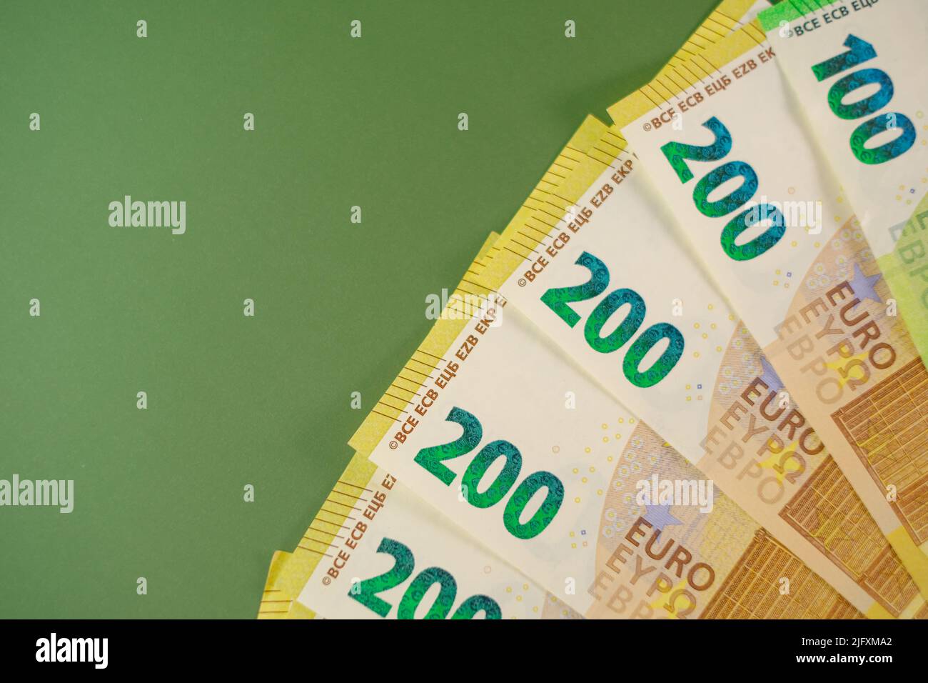 fifty euros banknotes on a green background.Euro currency.Money and finance.Spending and income in European countries.Euro currency exchange rate Stock Photo