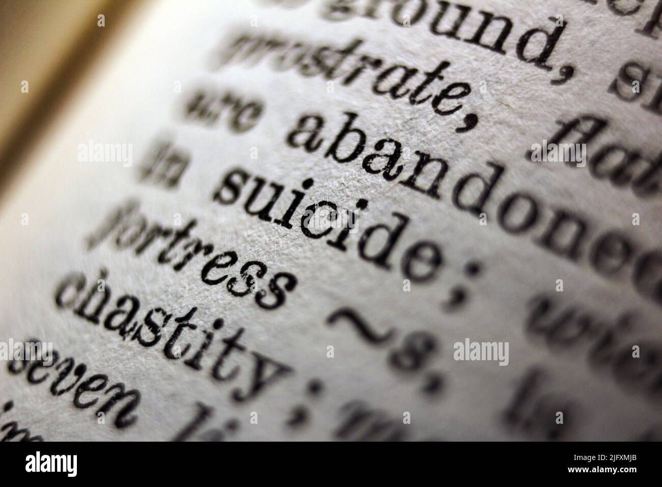 Word 'suicide' printed on dictionary page, macro close-up Stock Photo