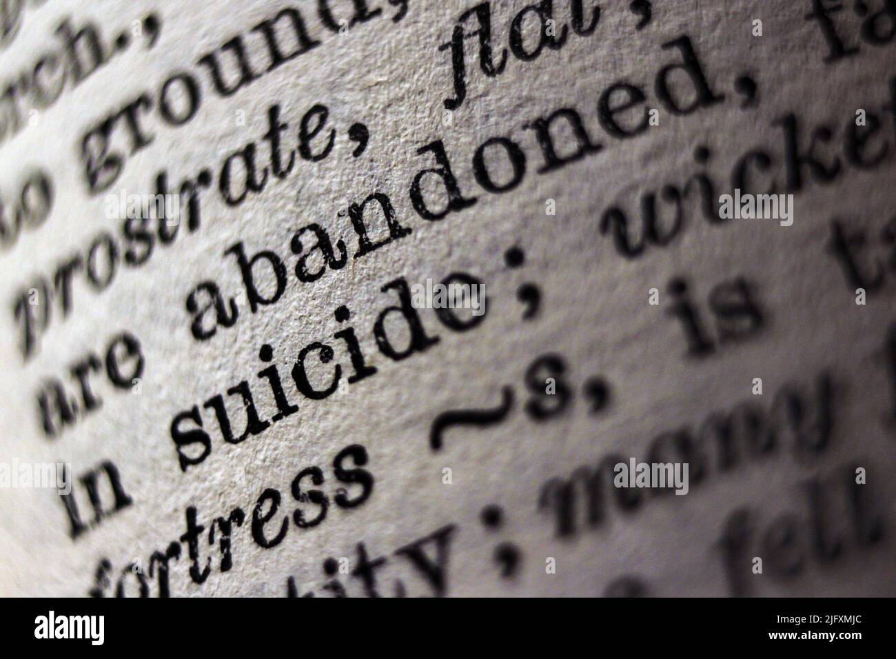 Word 'suicide' printed on dictionary page, macro close-up Stock Photo