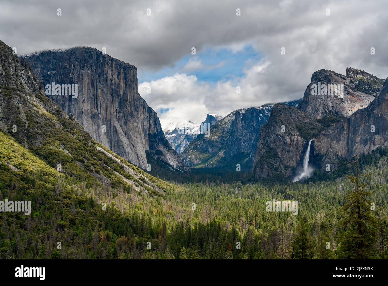 A Mesmerizing scene of El Capitan rocky mountain with snow and blue cloudy  sky Stock Photo