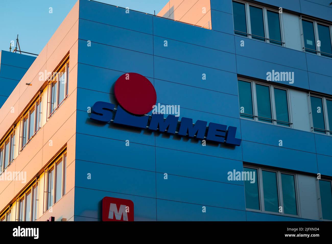 Simmel logo on a supermarket facade. Sign of the grocery store on the building exterior. Retail business in a German city. Big symbol on the wall. Stock Photo