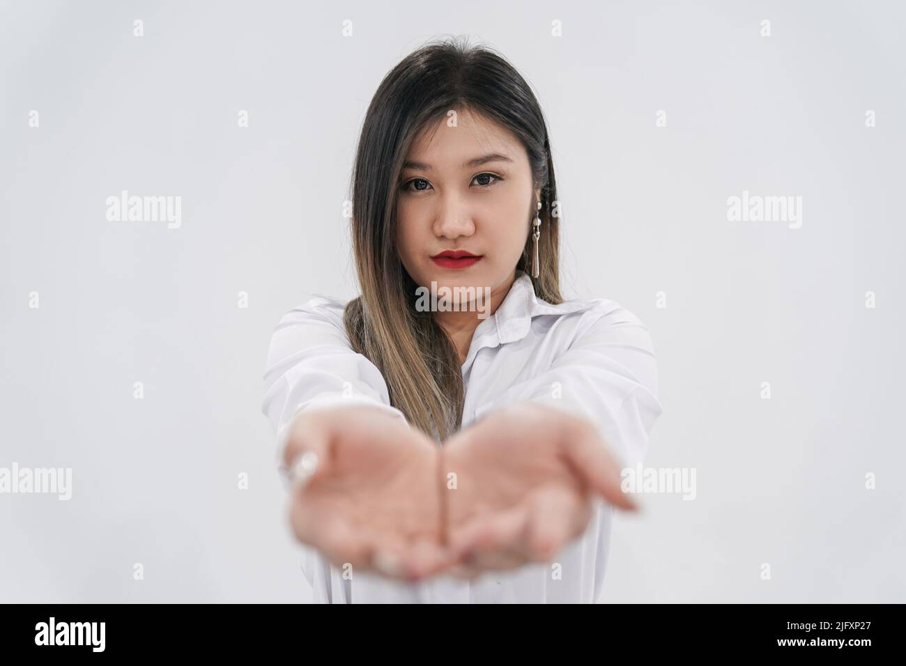 Empty thing in young Asian woman’s two hands are raised up in front of
