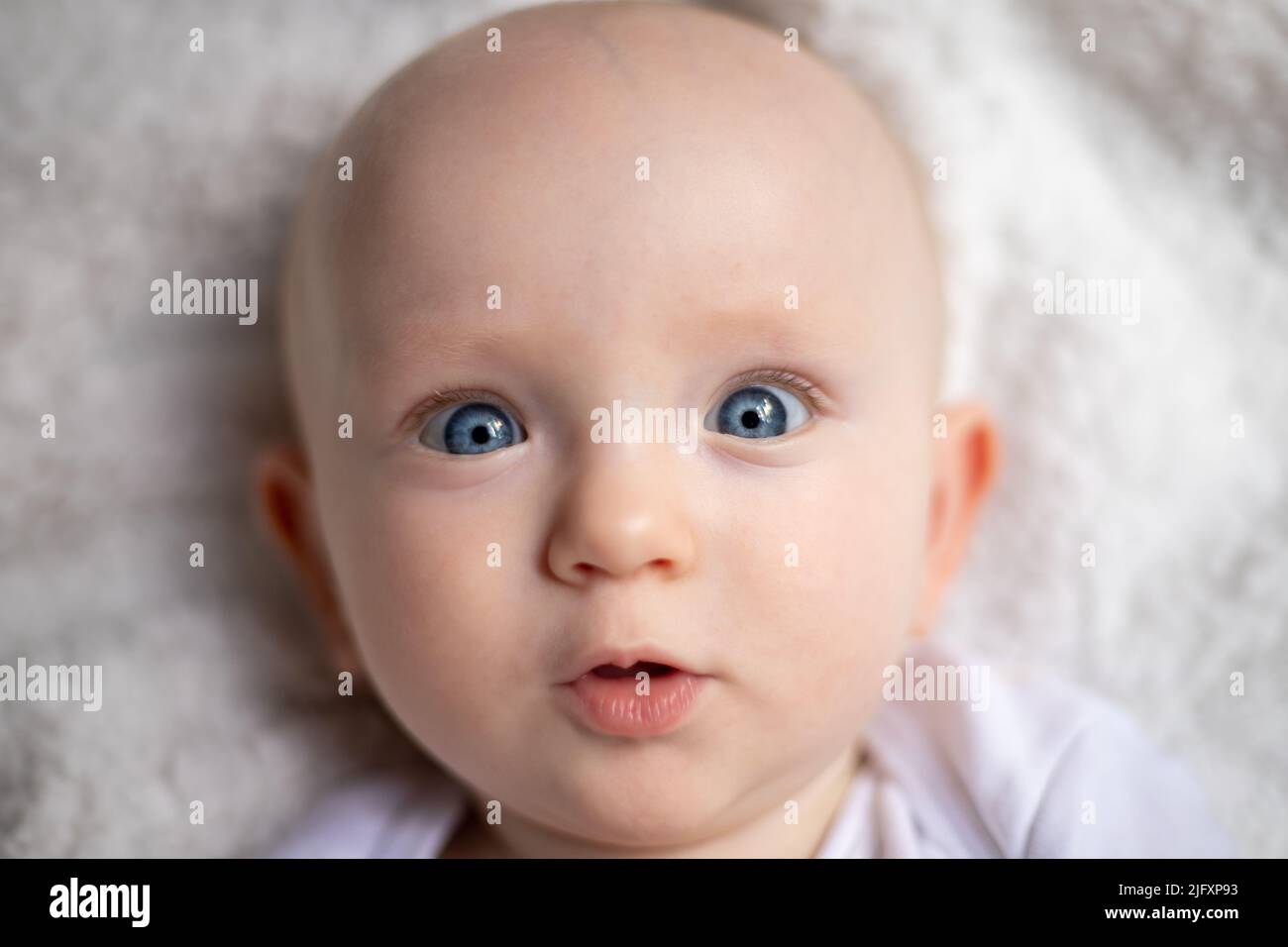 Children's portrait. Close-up of a face with bright blue eyes. Babies ...