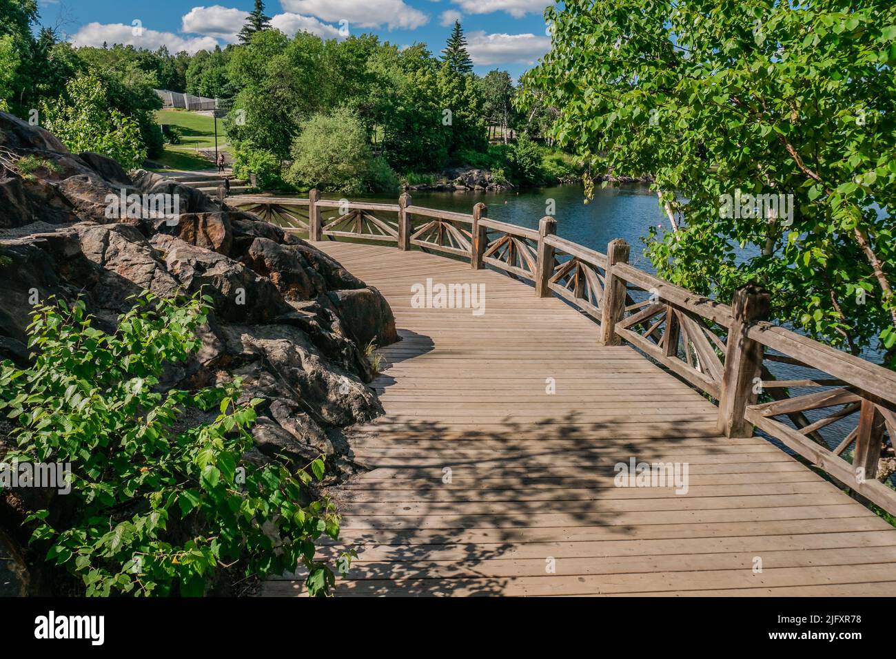 wooden bridge, urban park, sunny day Stock Photo