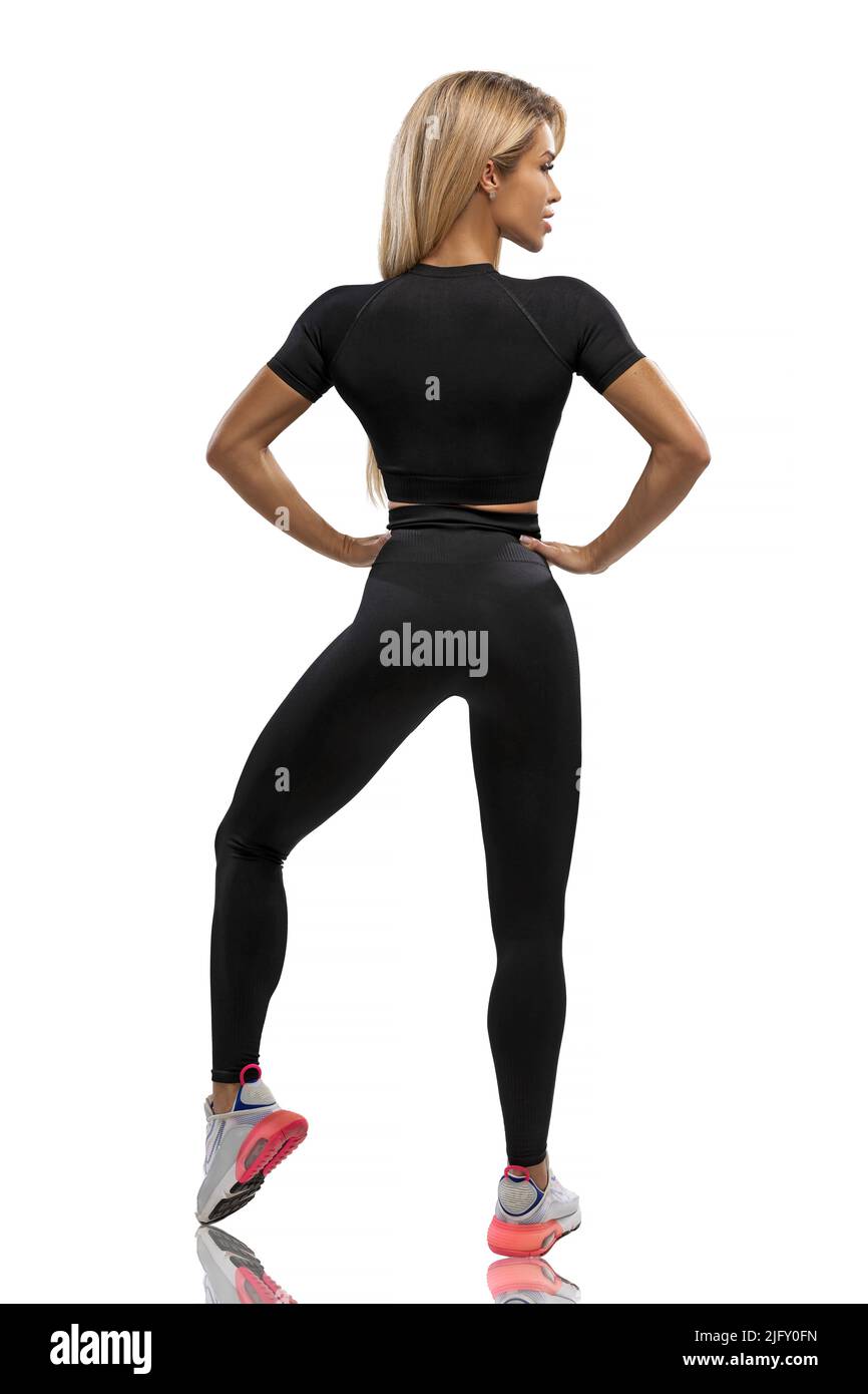 Blonde fit girl in black leggings and top on a white background in the  studio Stock Photo - Alamy