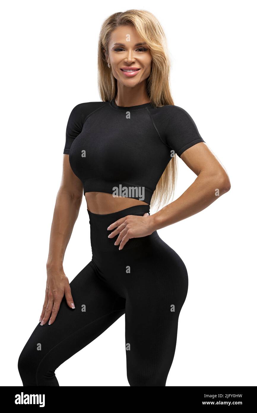 Blonde fit girl in leggings and top on a white background in the studio