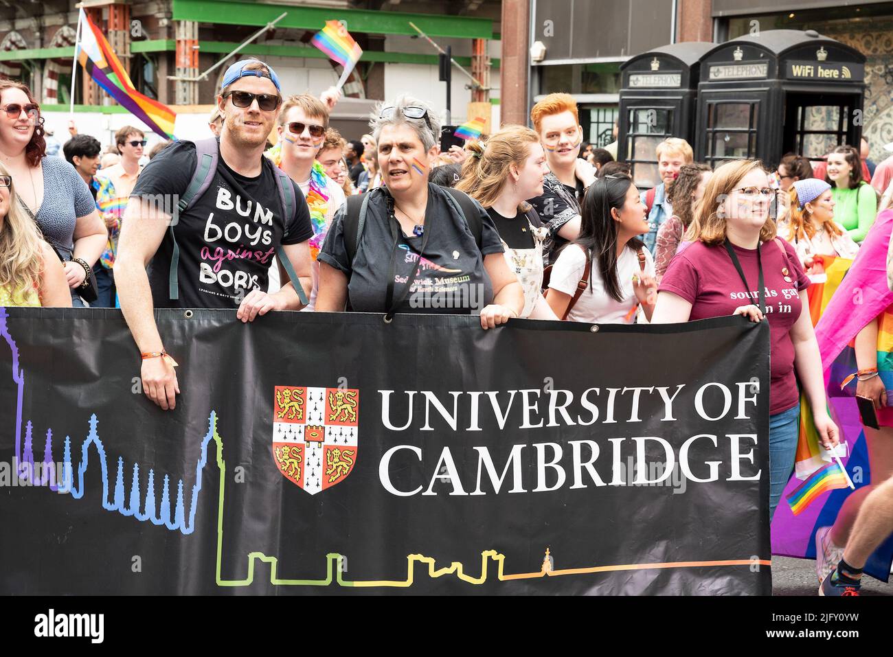 Piccadilly, London, UK. 2nd July 2022. London Pride March 2022. Celebrating 50 Years of Pride in the UK and following the same central London route taken in 1972. University of Cambridge banner and man wearing Bum Boys Against Boris tee shirt.  Credit: Stephen Bell/Alamy Stock Photo