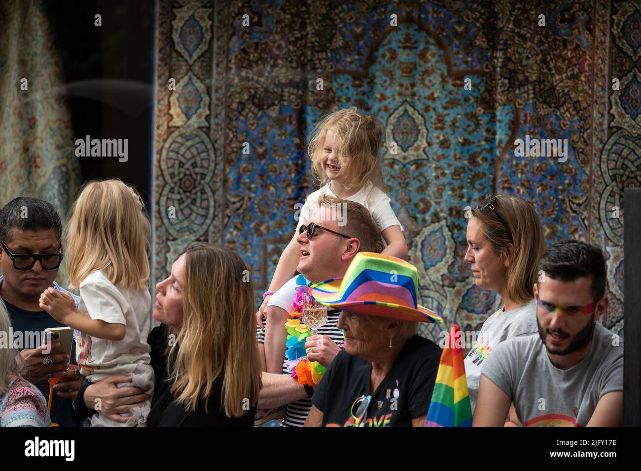 Piccadilly, London, UK. 2nd July 2022. London Pride March 2022. Celebrating 50 Years of Pride in the UK and following the same central London route taken in 1972. Roadside people watching the London Pride march with child on mans shoulders. Credit: Stephen Bell/Alamy Stock Photo
