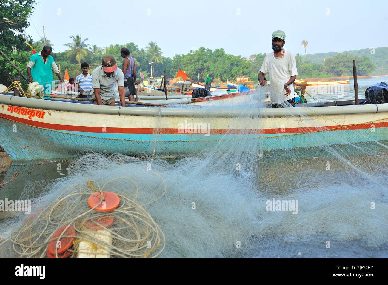 Indian fishermen preparing fishing nets for voyage at Achara