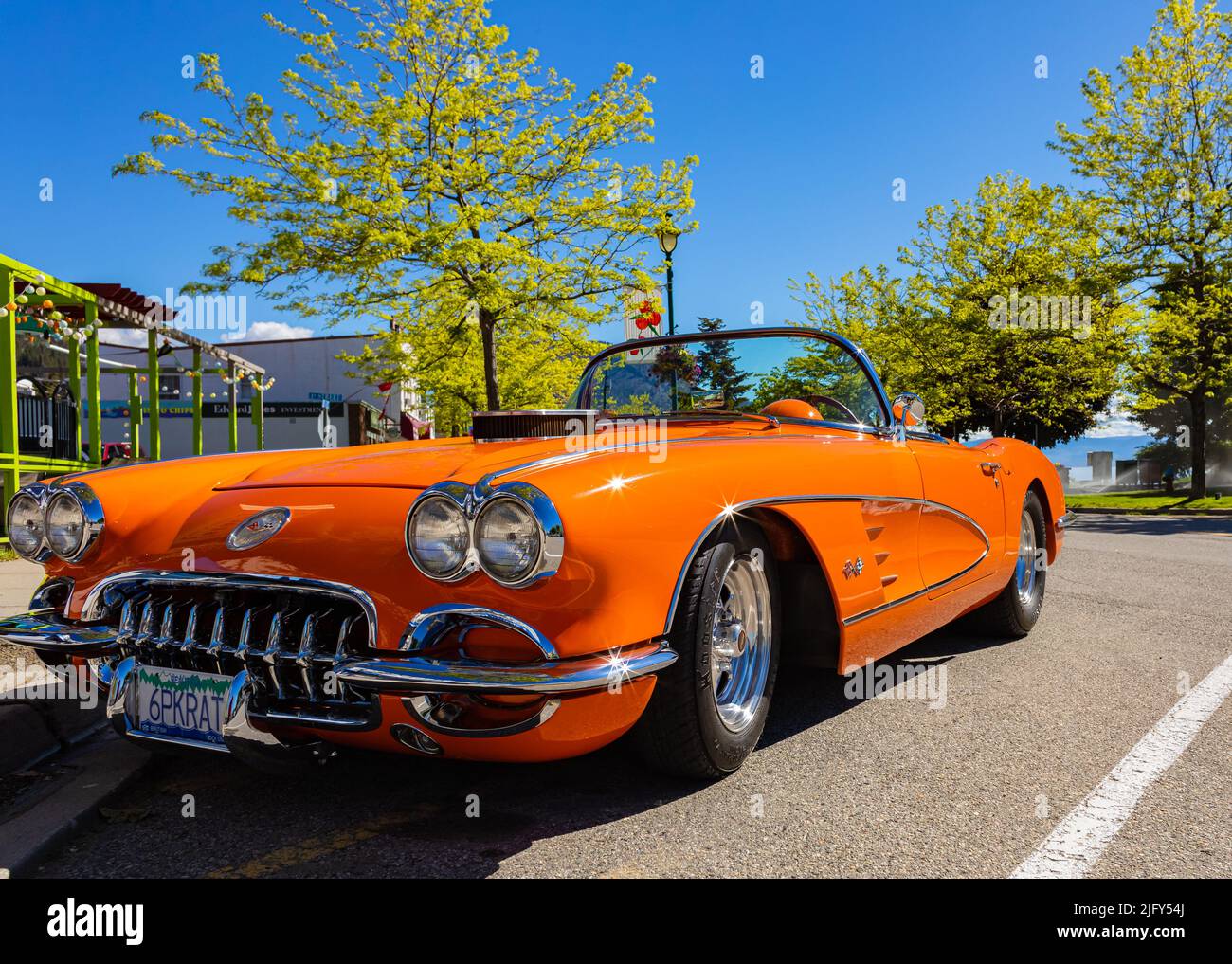 An orange 1959 Chevrolet Corvette Convertible is at summer park. Front view. Vintage Chevrolet Corvette a classic cabrio car-June 7,2022-Peachland BC Stock Photo