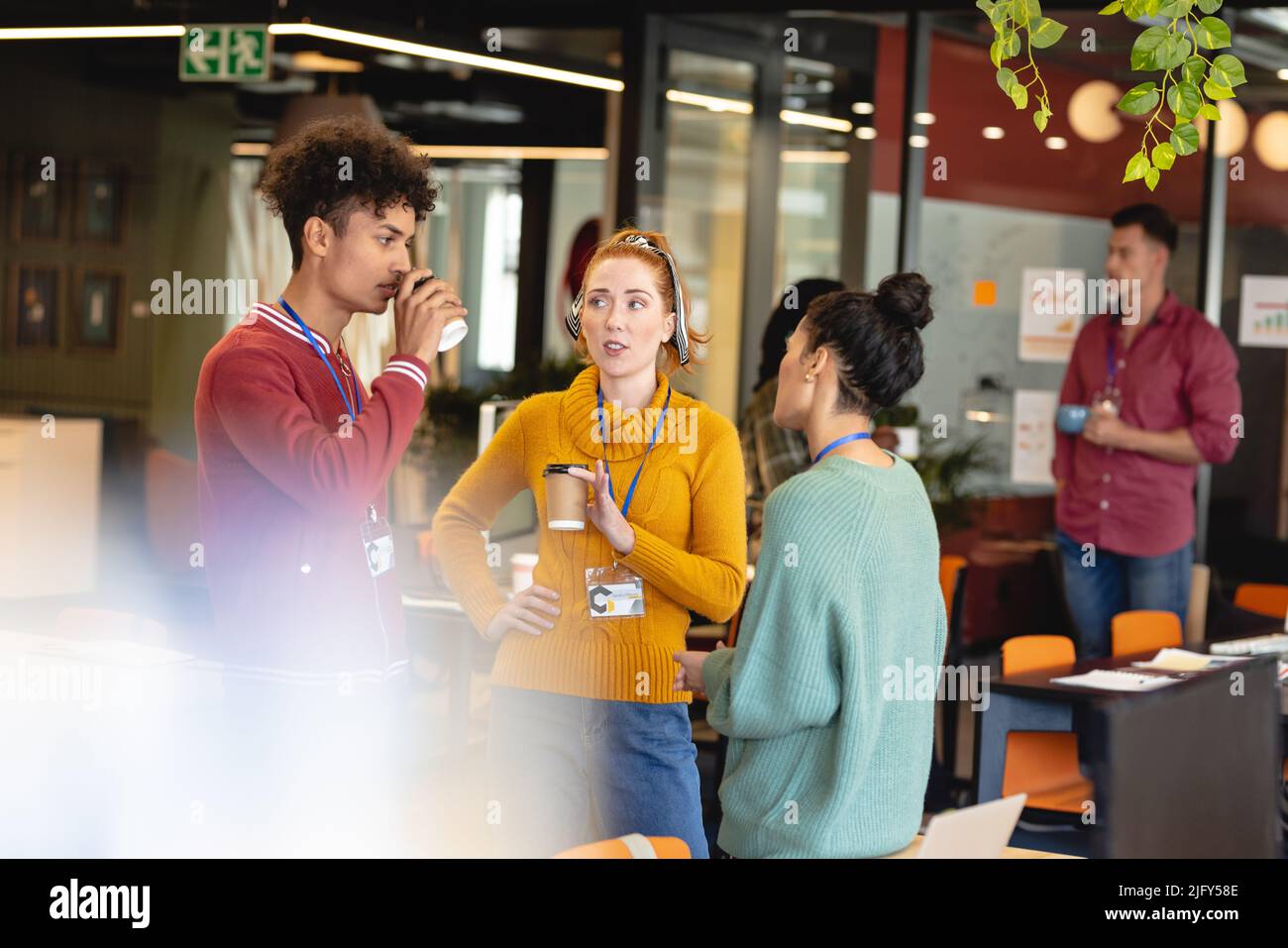Multiracial male and female design professionals discussing during ...