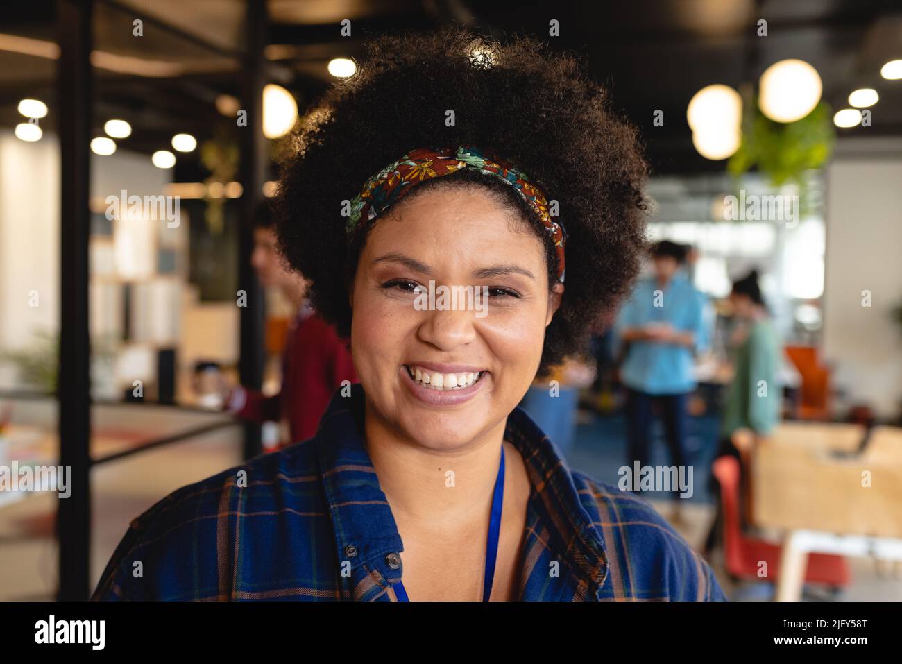 Portrait of smiling biracial female design professional in creative office Stock Photo