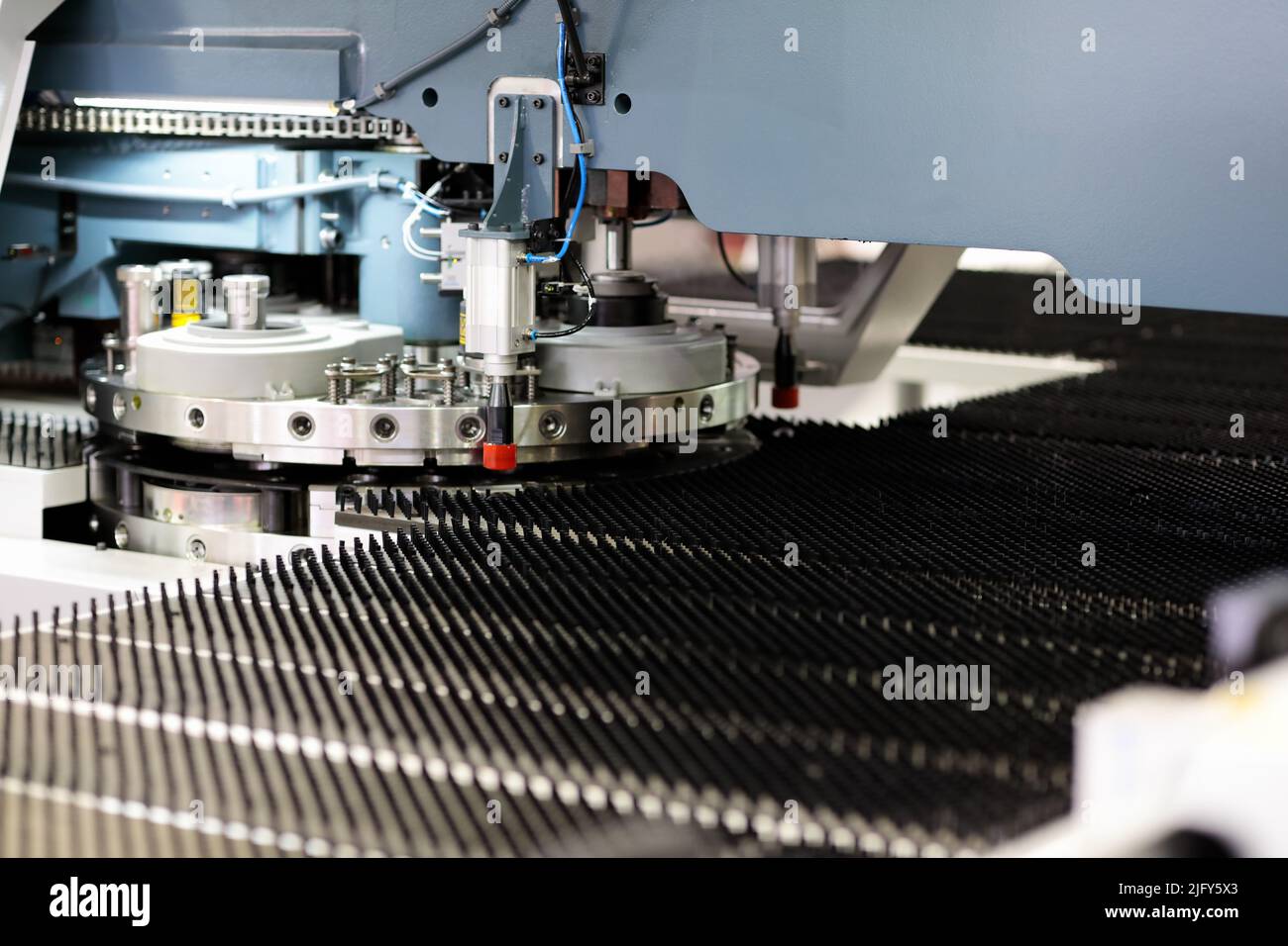 Industrial CNC turret punching machine close up. Selective focus. Stock Photo