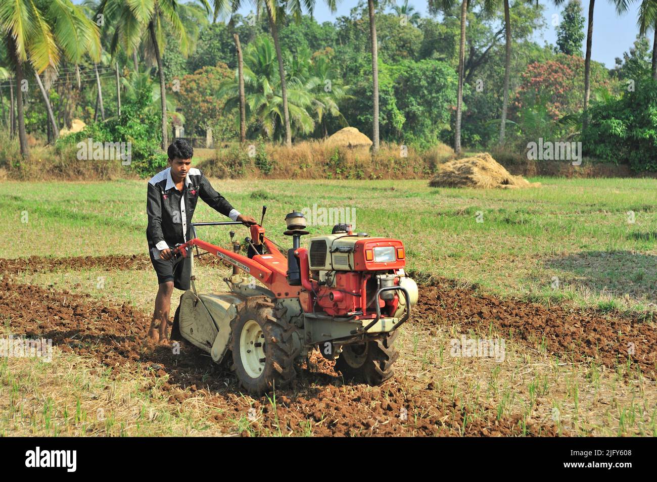 Farmer ploughing field with the help of power tiller at village Achara