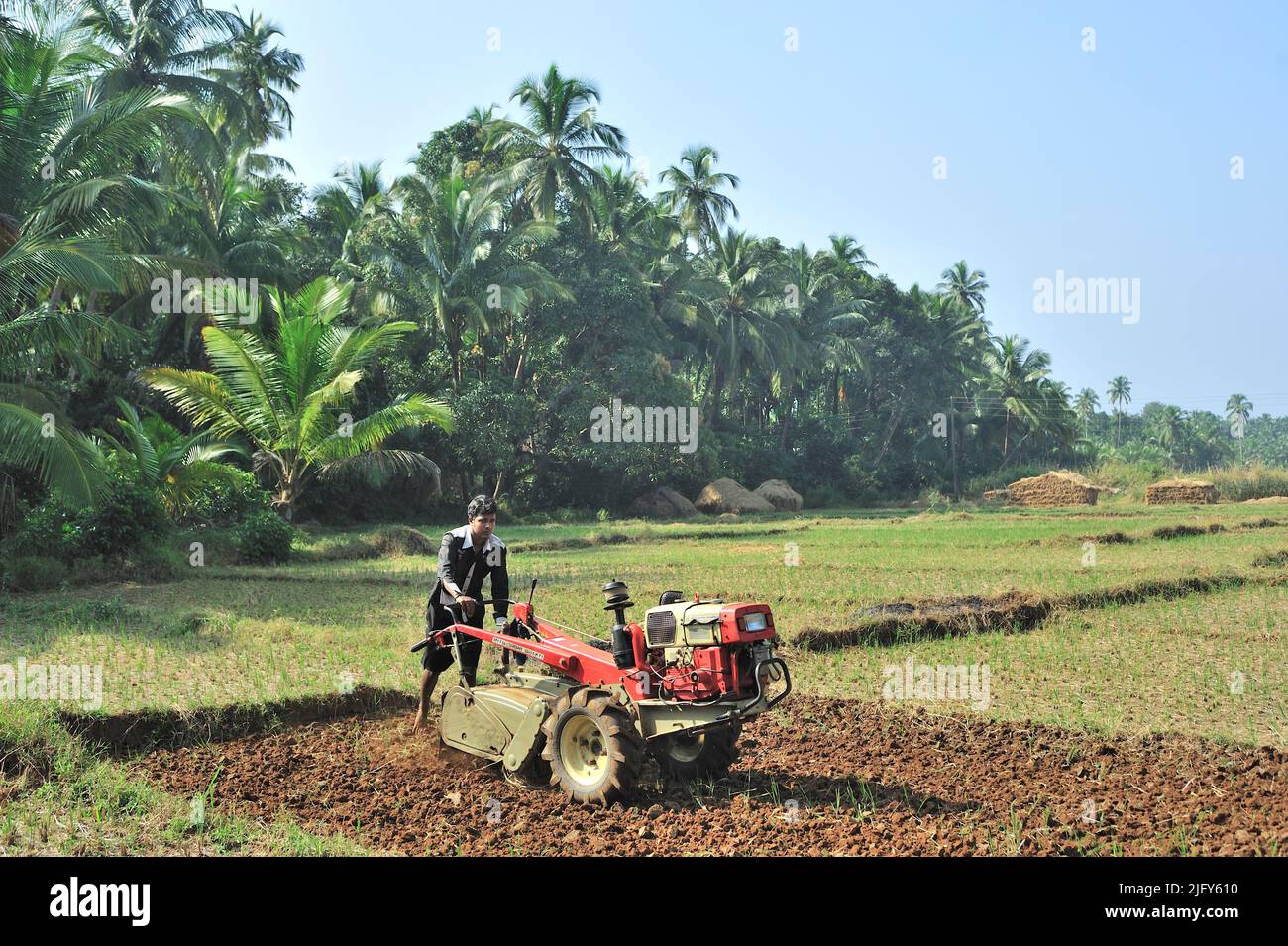 Farmer ploughing field with the help of power tiller at village Achara