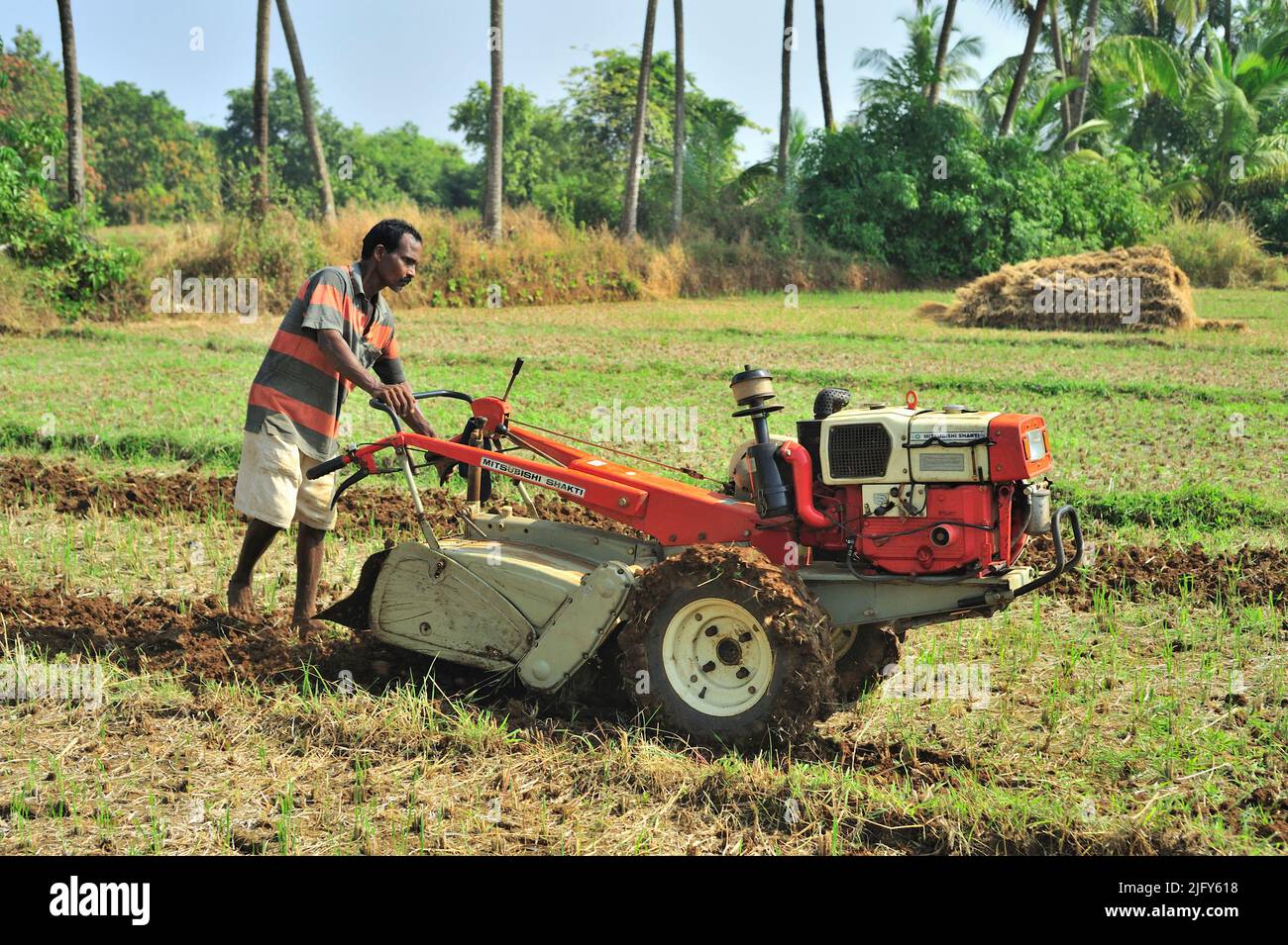 Farmer ploughing field with the help of power tiller at village Achara