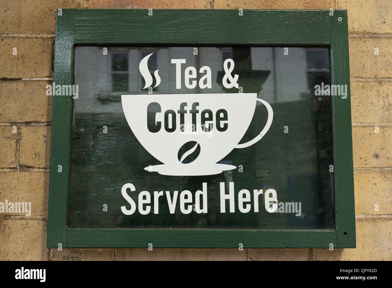 Green tea and coffee served here sign hanging on a wall at knaresborough railway station North Yorkshire, UK Stock Photo