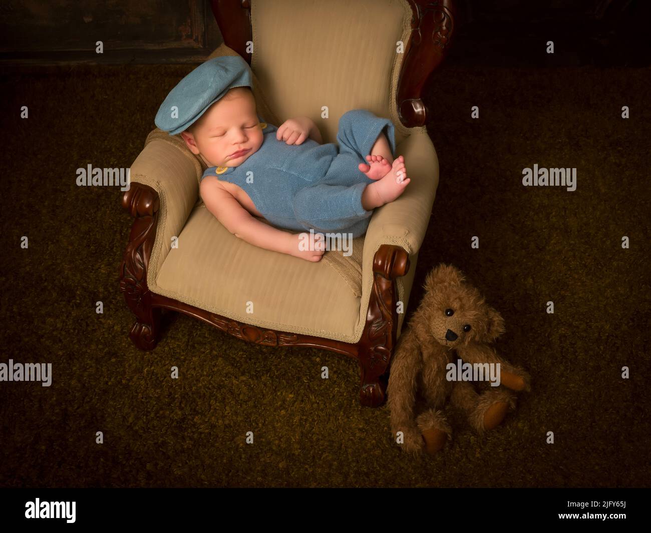 Newborn baby of 7 days old sleeping on an antique French armchair Stock Photo