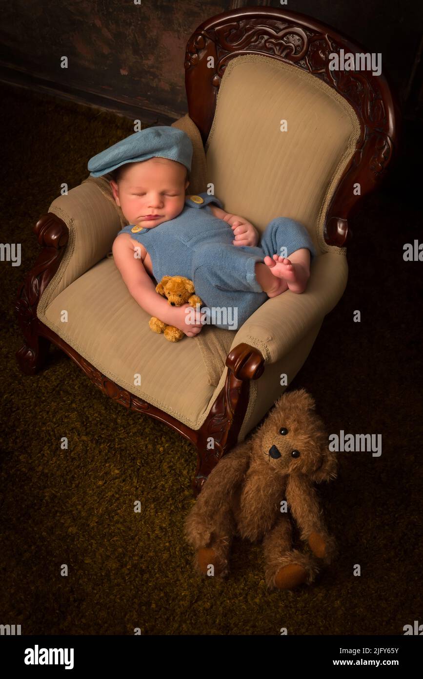 Newborn baby of 7 days old sleeping on an antique French armchair Stock Photo