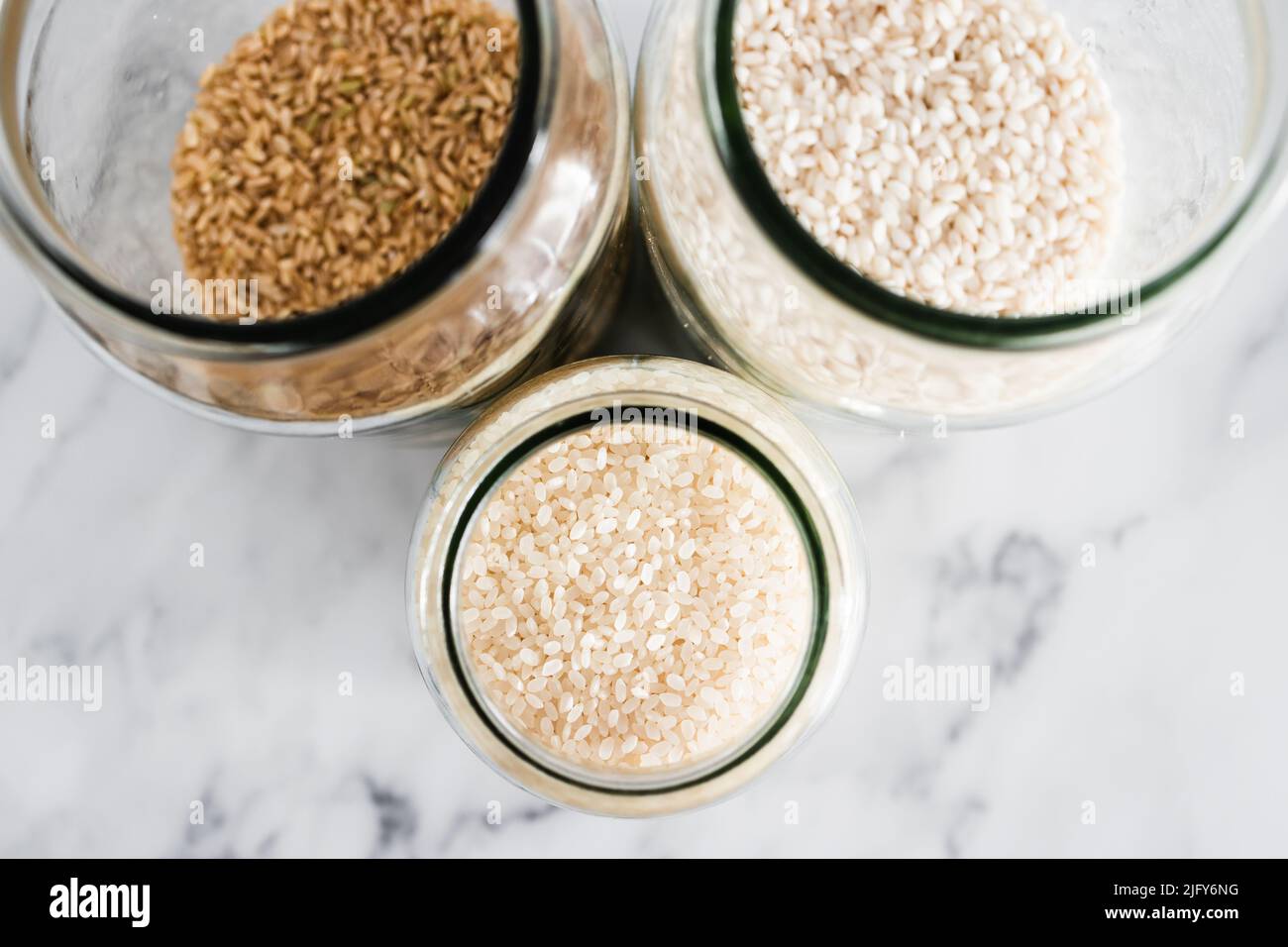 pantry jars with different types of rice including brown arborio and