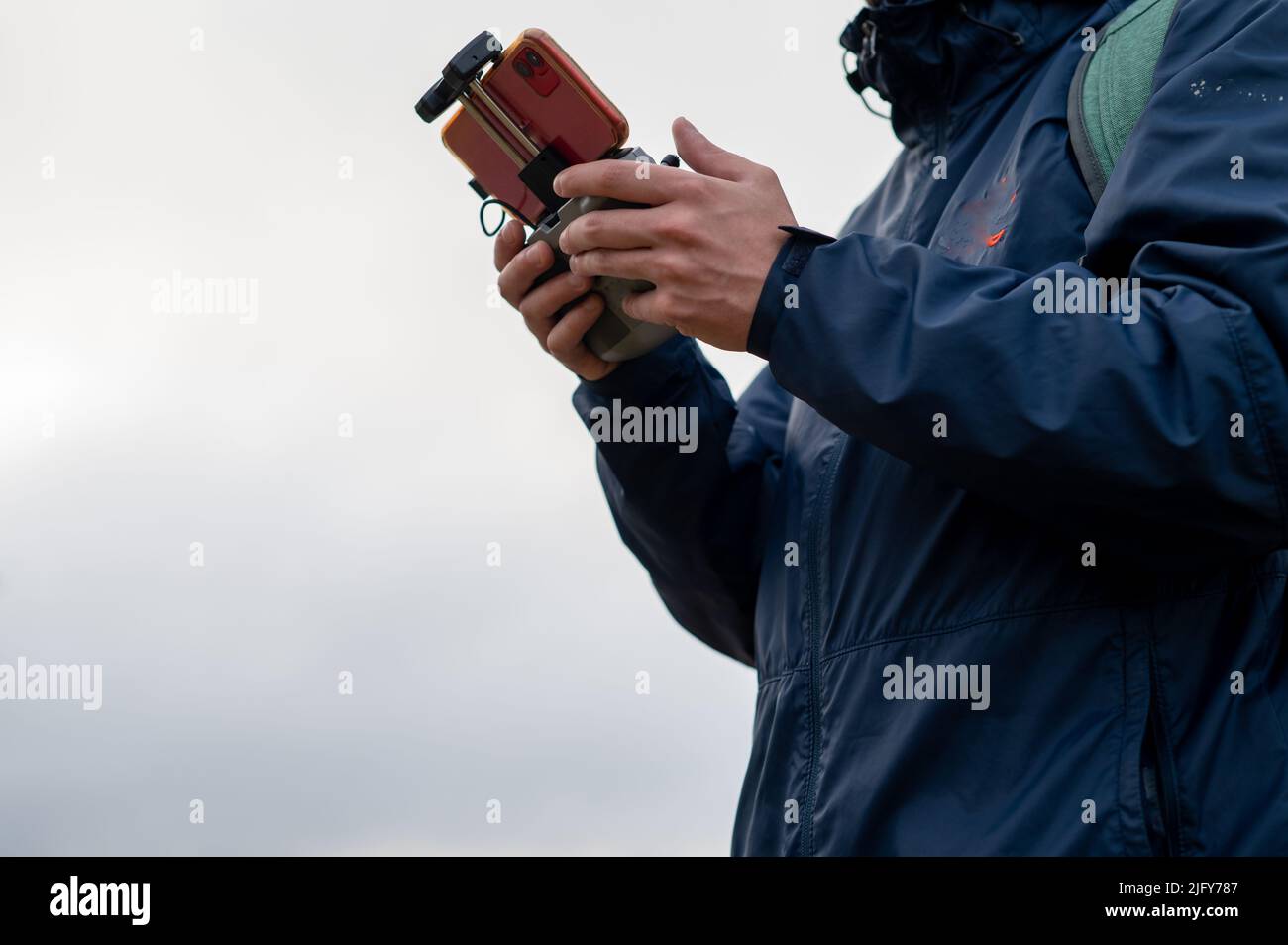 Person flying a drone shot with controller in hand Stock Photo