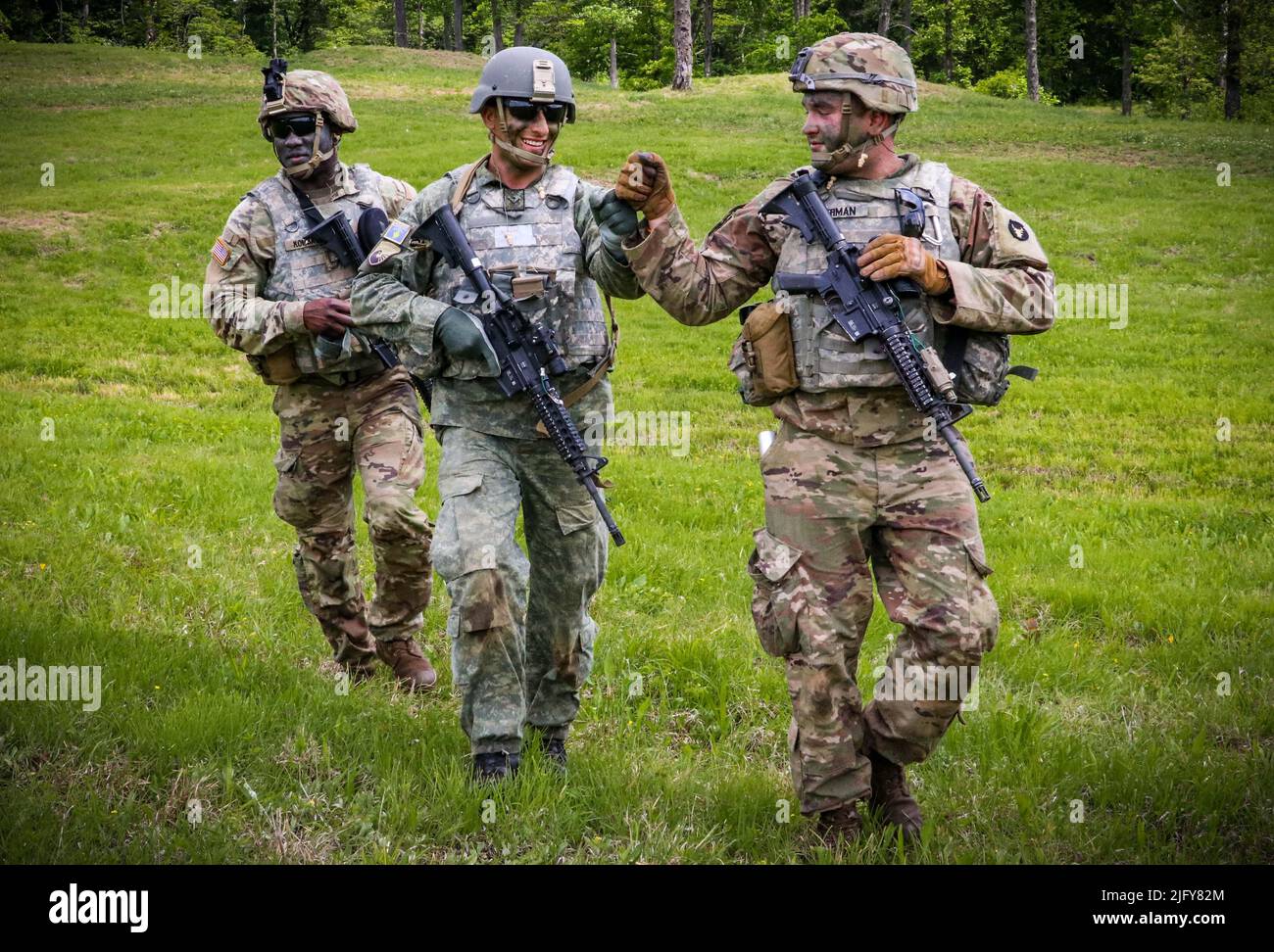 May 19, 2022 - Camp Atterbury, Indiana, USA - Spc. Noah Bierman, a West Liberty, Iowa, native and infantryman assigned to Company B, 1st Battalion, 133rd Infantry Regiment, fist bumps a member of the Kosovo Security Force after completing a wedge formation live-fire exercise at Camp Atterbury, Indiana, on May 19, 2022. Approximately 15 KSF troops embedded with companies in the 1-133rd Infantry during a two-week annual training exercise. Two KSF troops conducted the live-fire exercise with the U.S. infantrymen. Senior leaders in the IANG and KSF visited each company near the end of the exercise Stock Photo