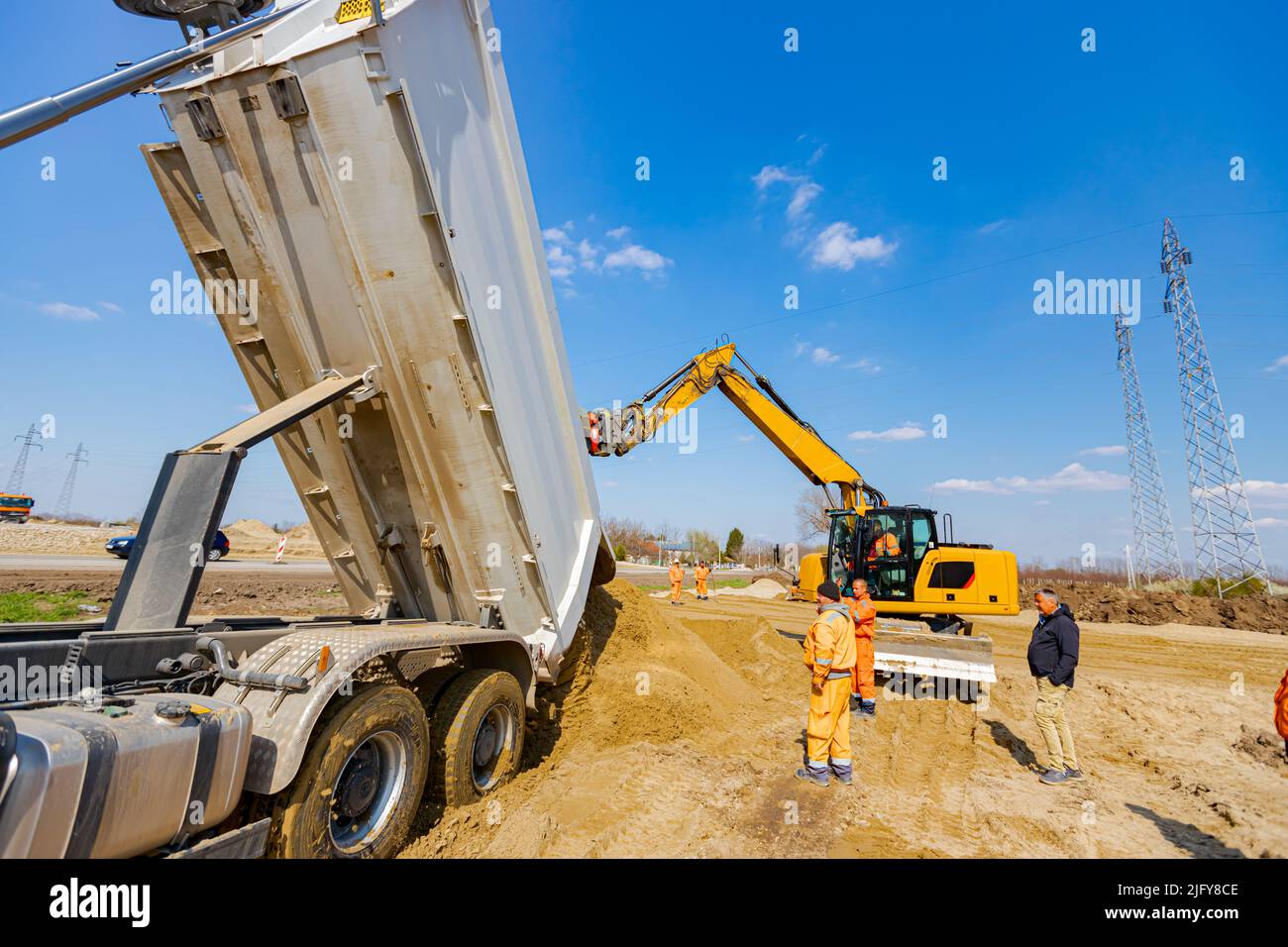 Dumper truck is unloading soil or sand at construction site Stock Photo ...