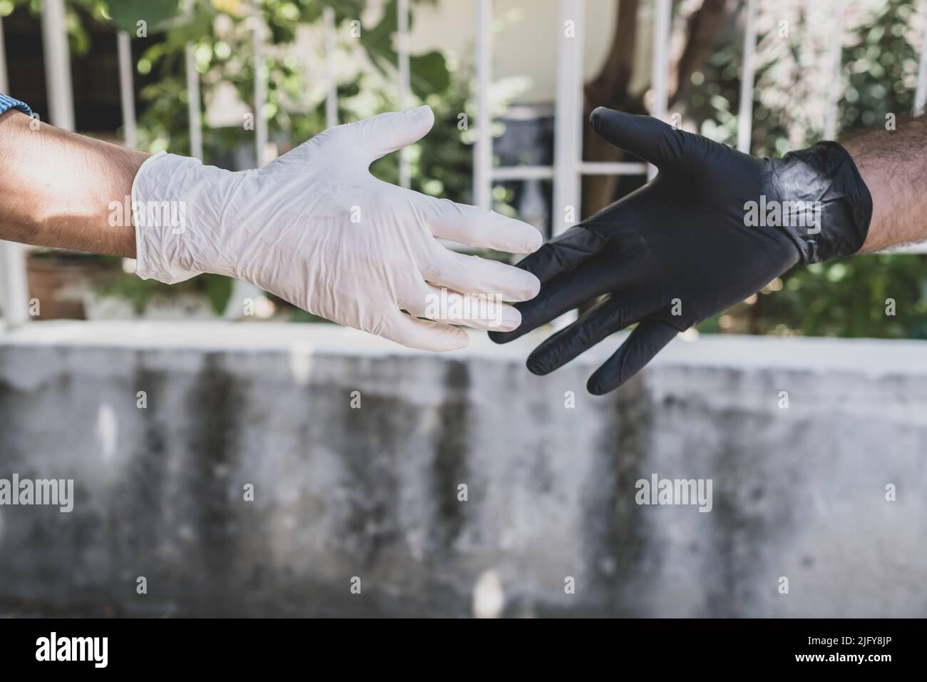 wearing gloves to stay away from smallpox. no contact Stock Photo Alamy