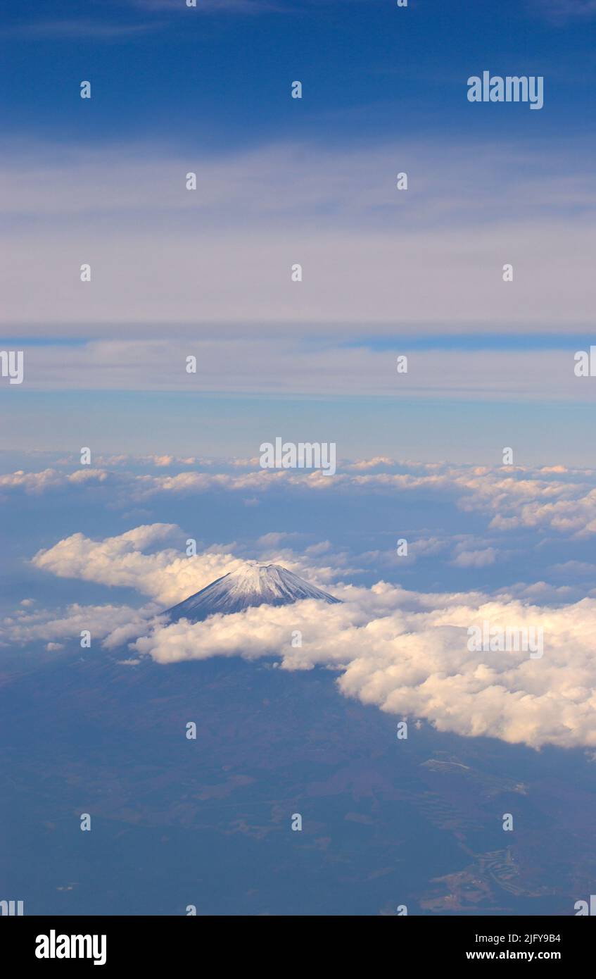 The snow covered peak of Fuji San (Fujiyama) in early fall seen from an airplane, Yamanashi Japan JP Stock Photo