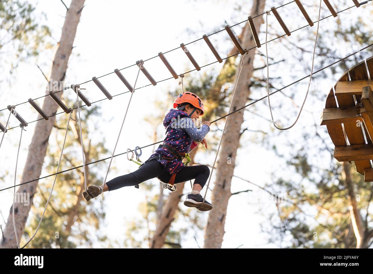 Girl Standing With Rope Little girl is standing on a rope, holding a rope with his hands. A ...