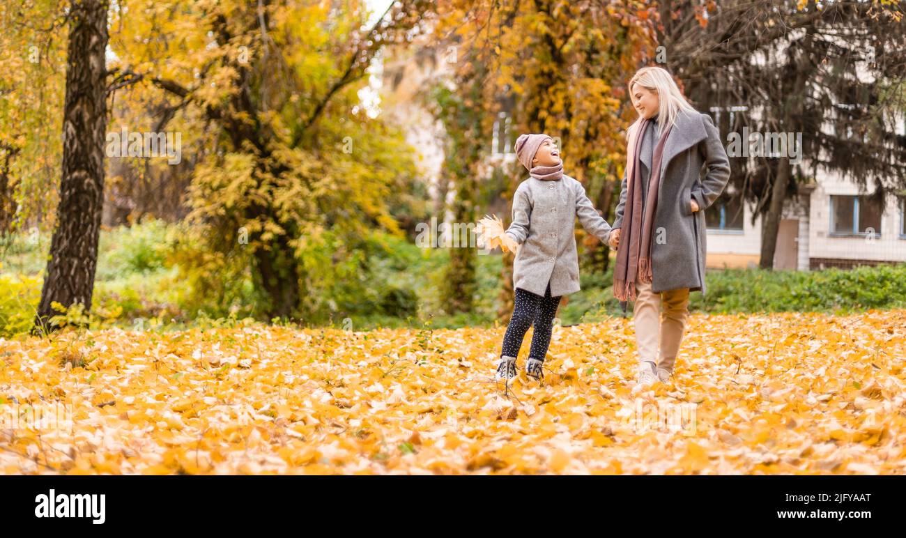 Mother and daughter in autumn yellow park Stock Photo - Alamy