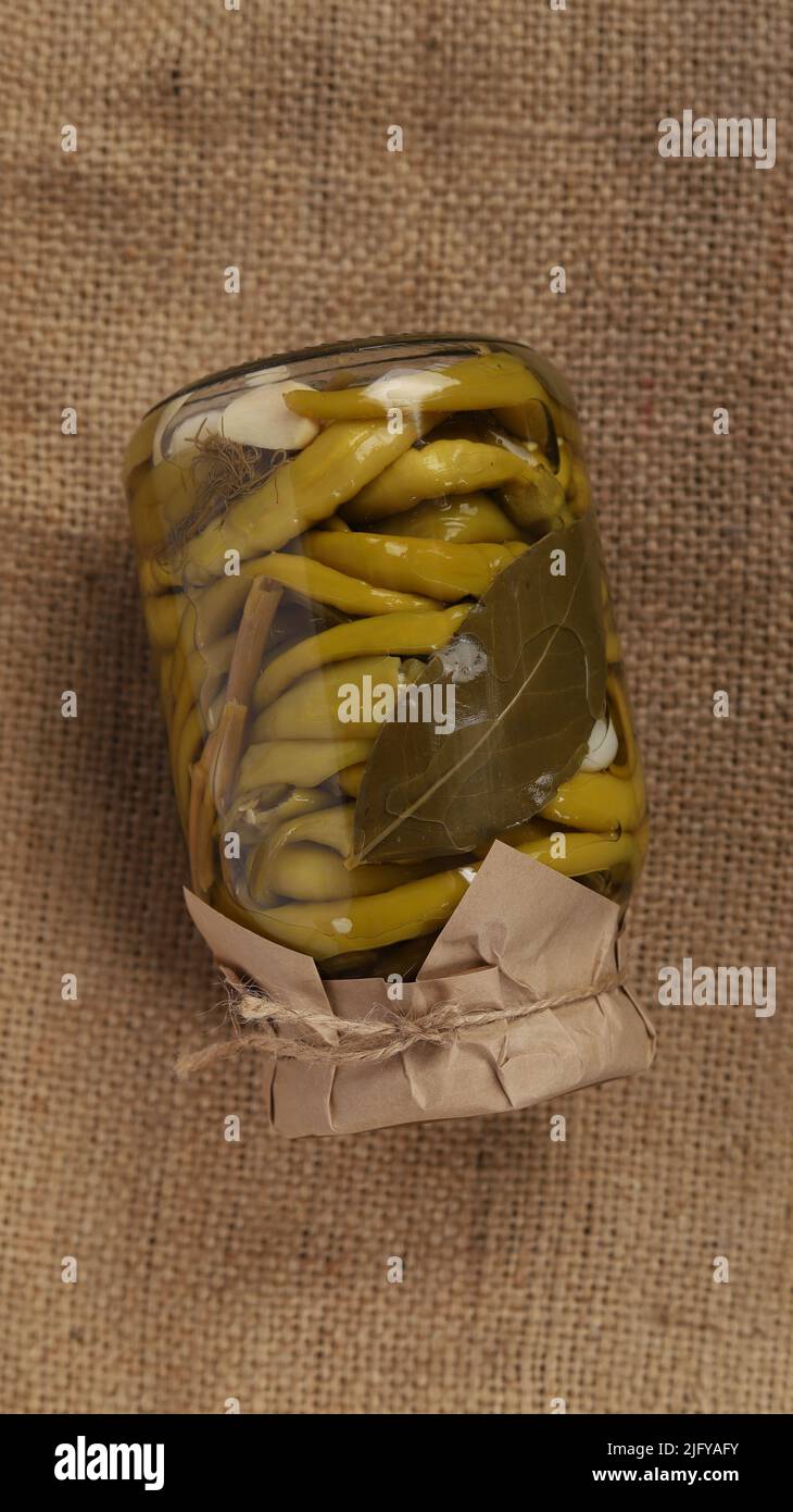A vertical view of the homemade canned chili pepper in a mason jar