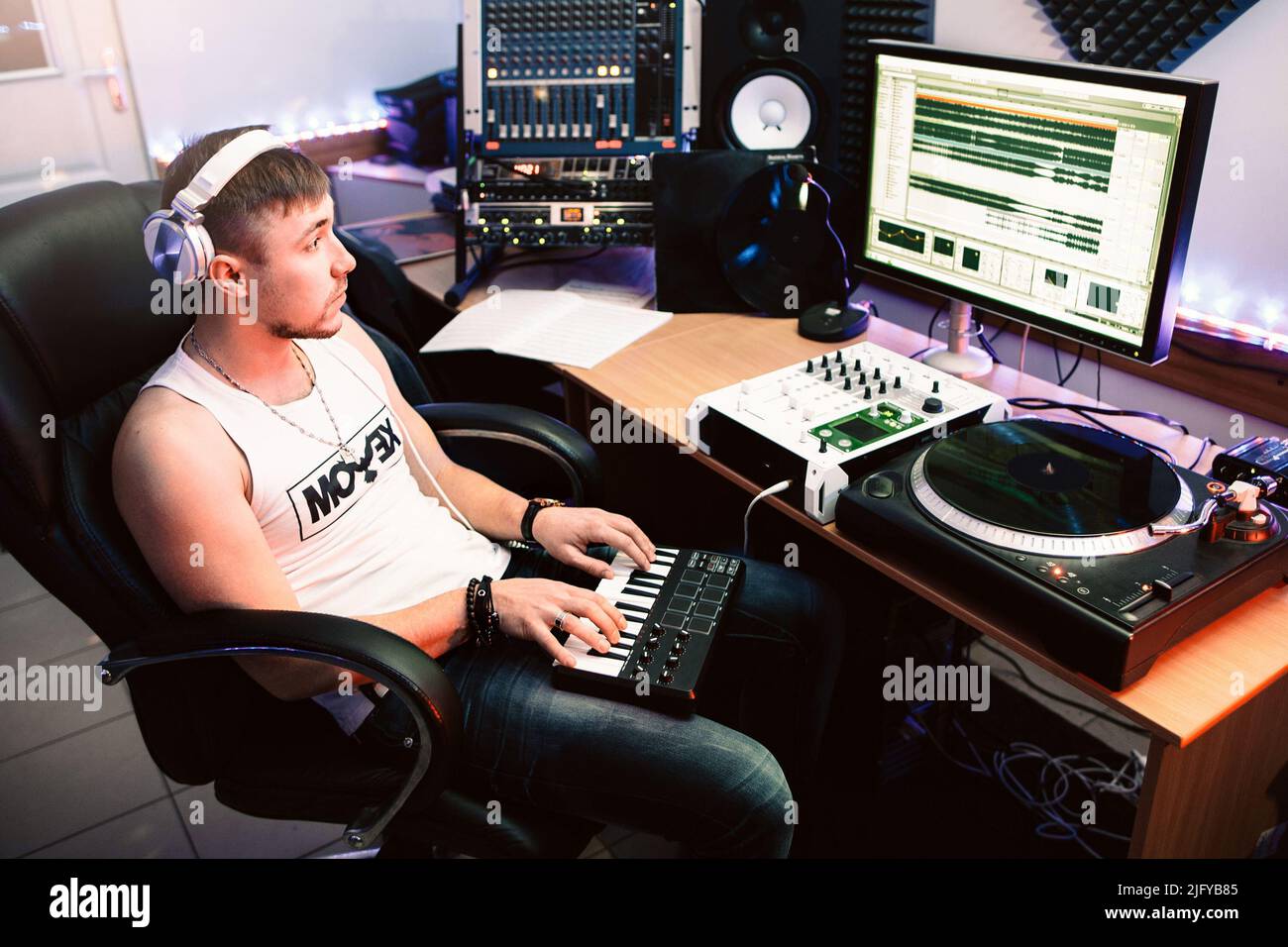 DJ playing piano in the recording studio Stock Photo