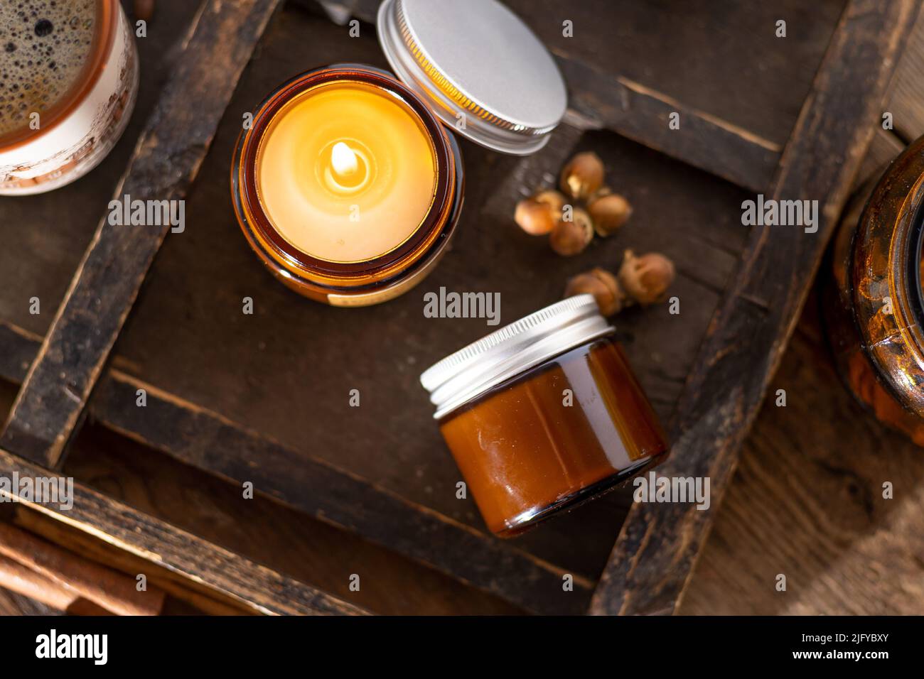 A set of different aroma candles in brown glass jars. Scented handmade ...