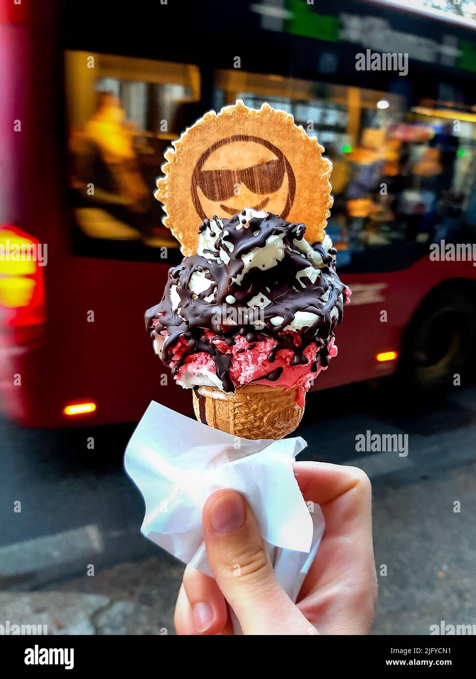 Holding a cone with two scoops of ice cream in a beautiful day in Rome Stock Photo