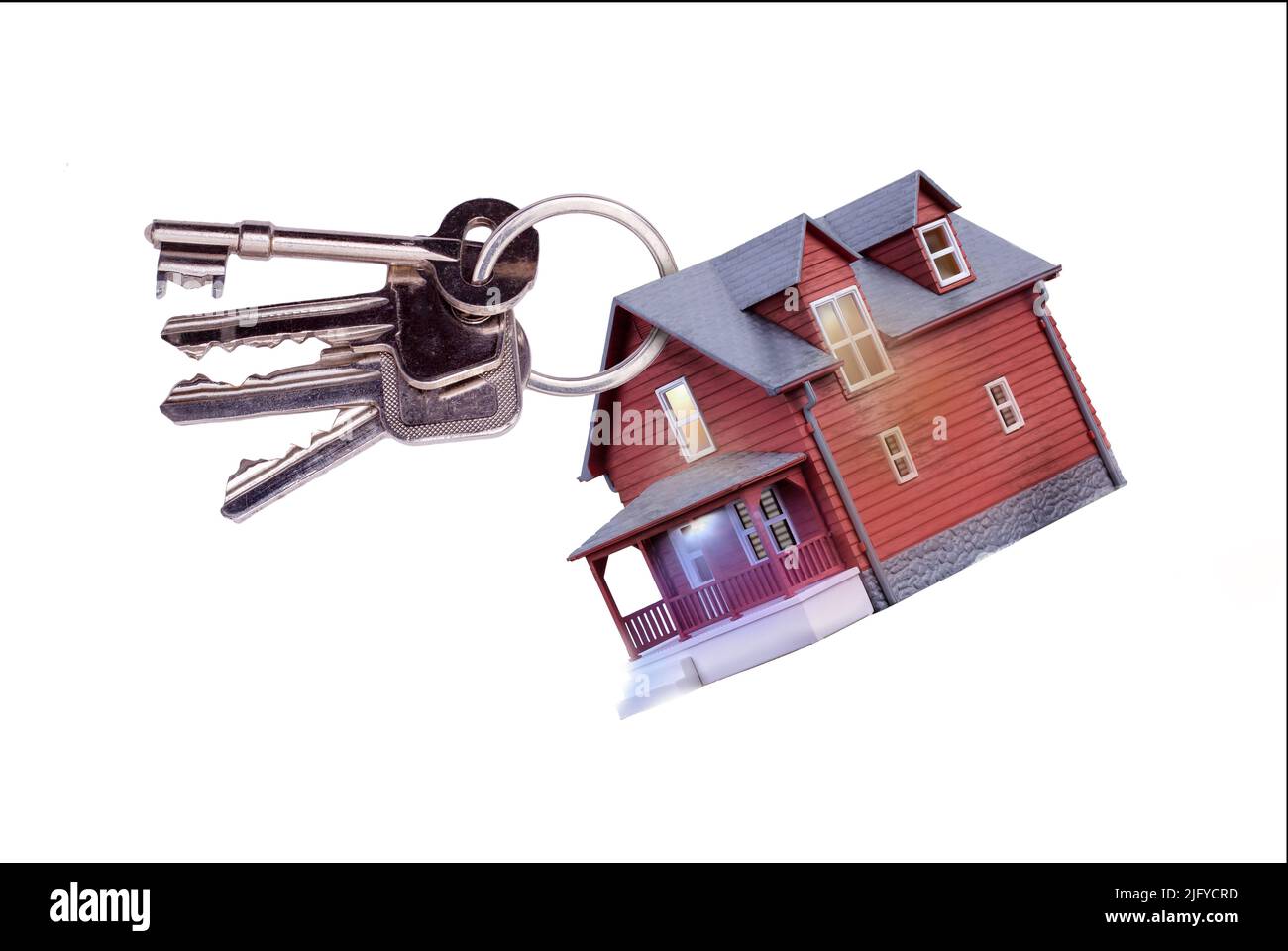 Toy house on keyring with keys to a home isolated on a white background. Concept for house sales, home ownership, estate agents, house insurance and b Stock Photo