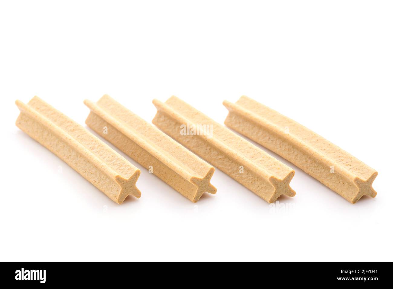 Close up X-Shape dental stick for puppy to reduce tartar build-up isolated on white background Stock Photo