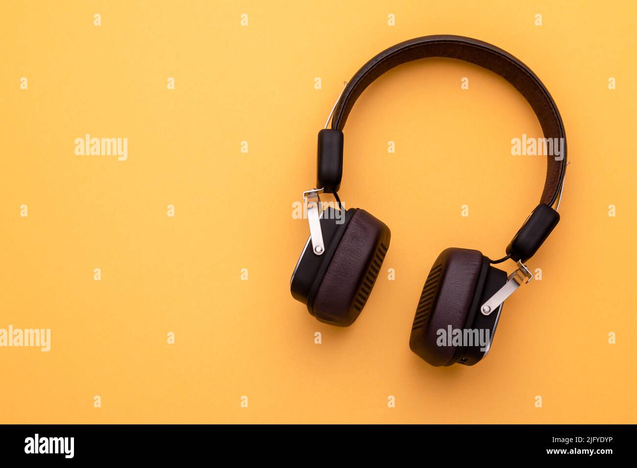 Top view black Headphone or Headset on bright color background. Copy space for text or design Stock Photo