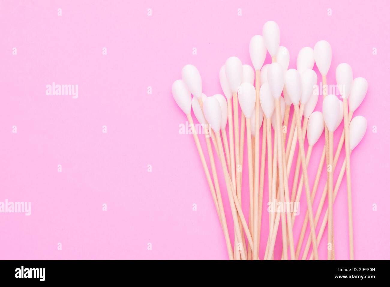 Top view cotton bud for cleaning the ears on pink background Stock Photo