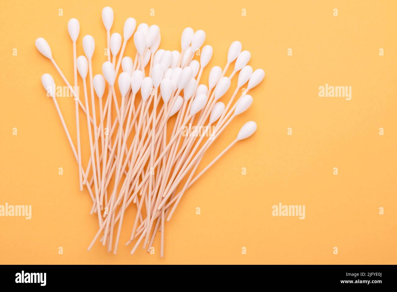 Top view cotton bud for cleaning the ears on yellow background Stock