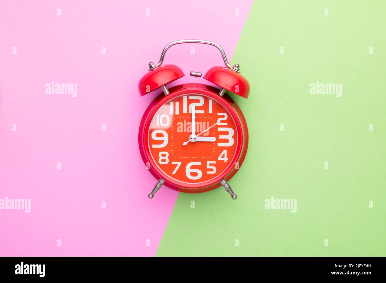Top view old red alarm clock on bright color background Stock Photo
