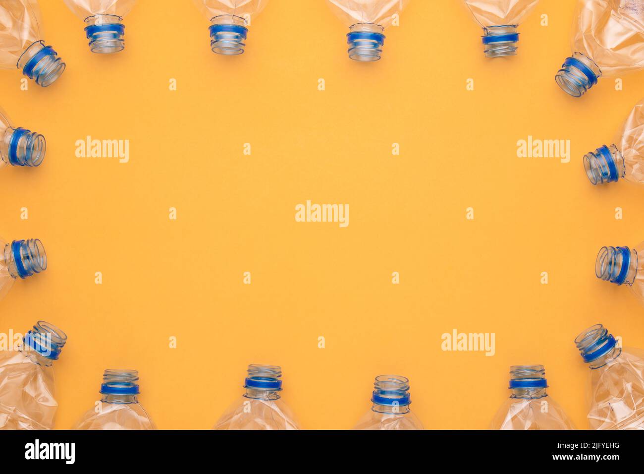 Top view old clear plastic water bottle on yellow background Stock Photo