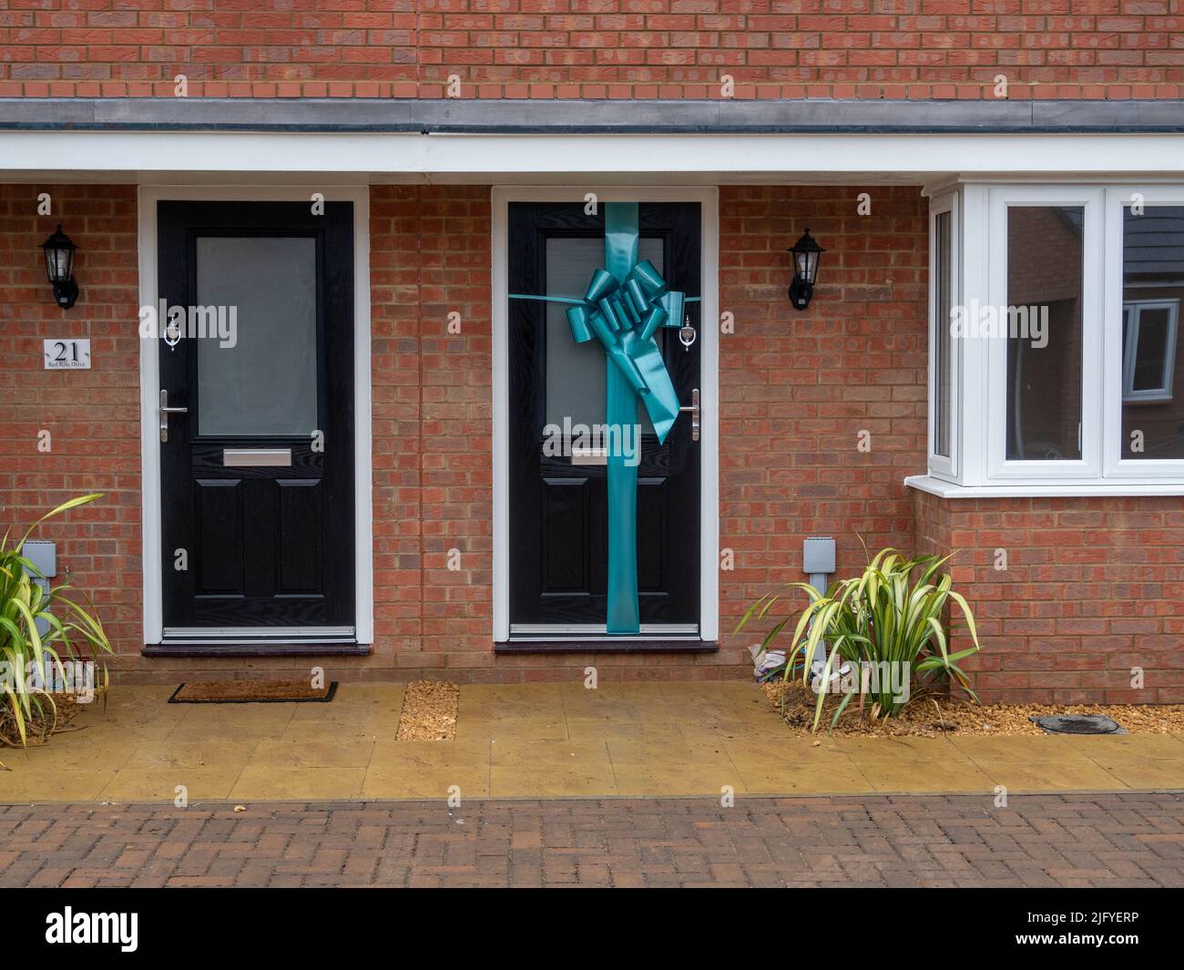 Newly built house with a ribbon around the front door to the