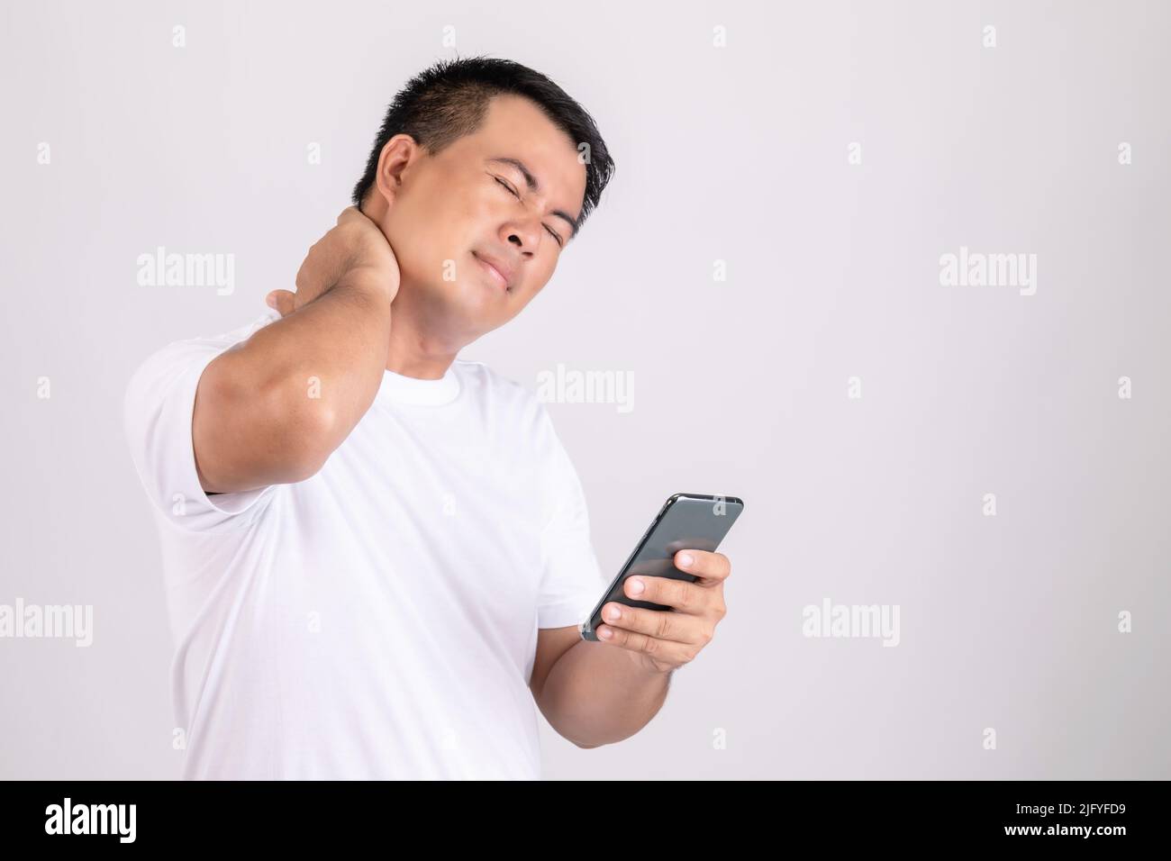 Neck pain concept. Man touching his neck because pain or hurt after