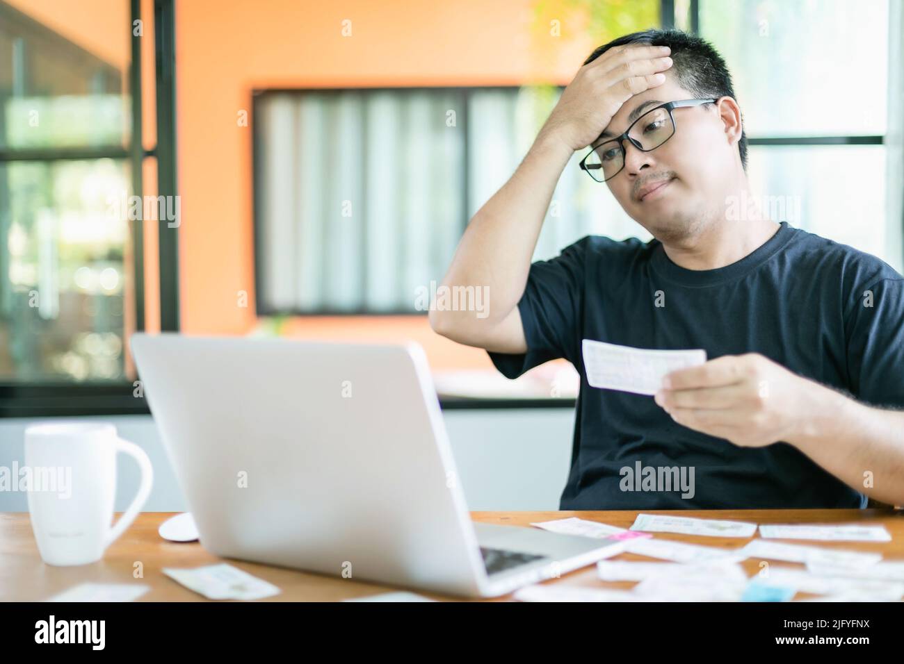 Feeling fail about government lottery concept : Thai people checking the result of Thailand government lottery on laptop and felling fail or sad. Sele Stock Photo
