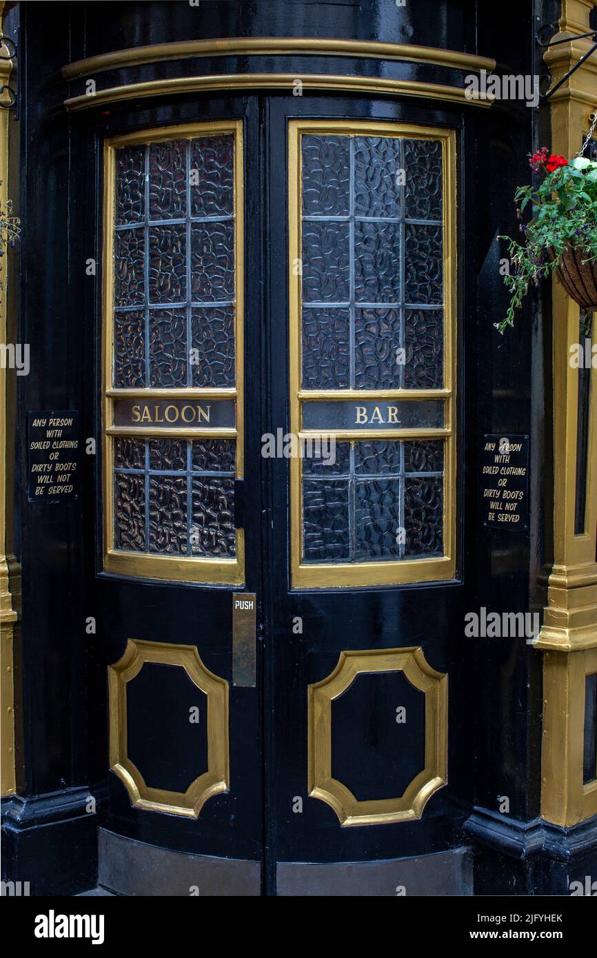 Exterior shot of the curved glass front door from the Cockpit pub in St Andrew's Hill in the City of London. Stock Photo