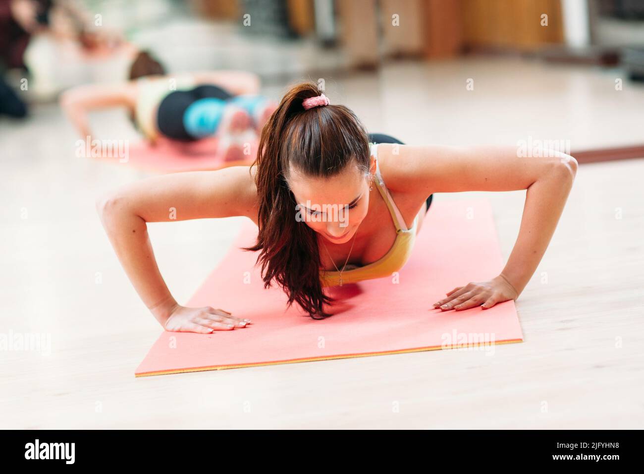 Gym training. Hands day. Fit woman doing push ups Stock Photo - Alamy