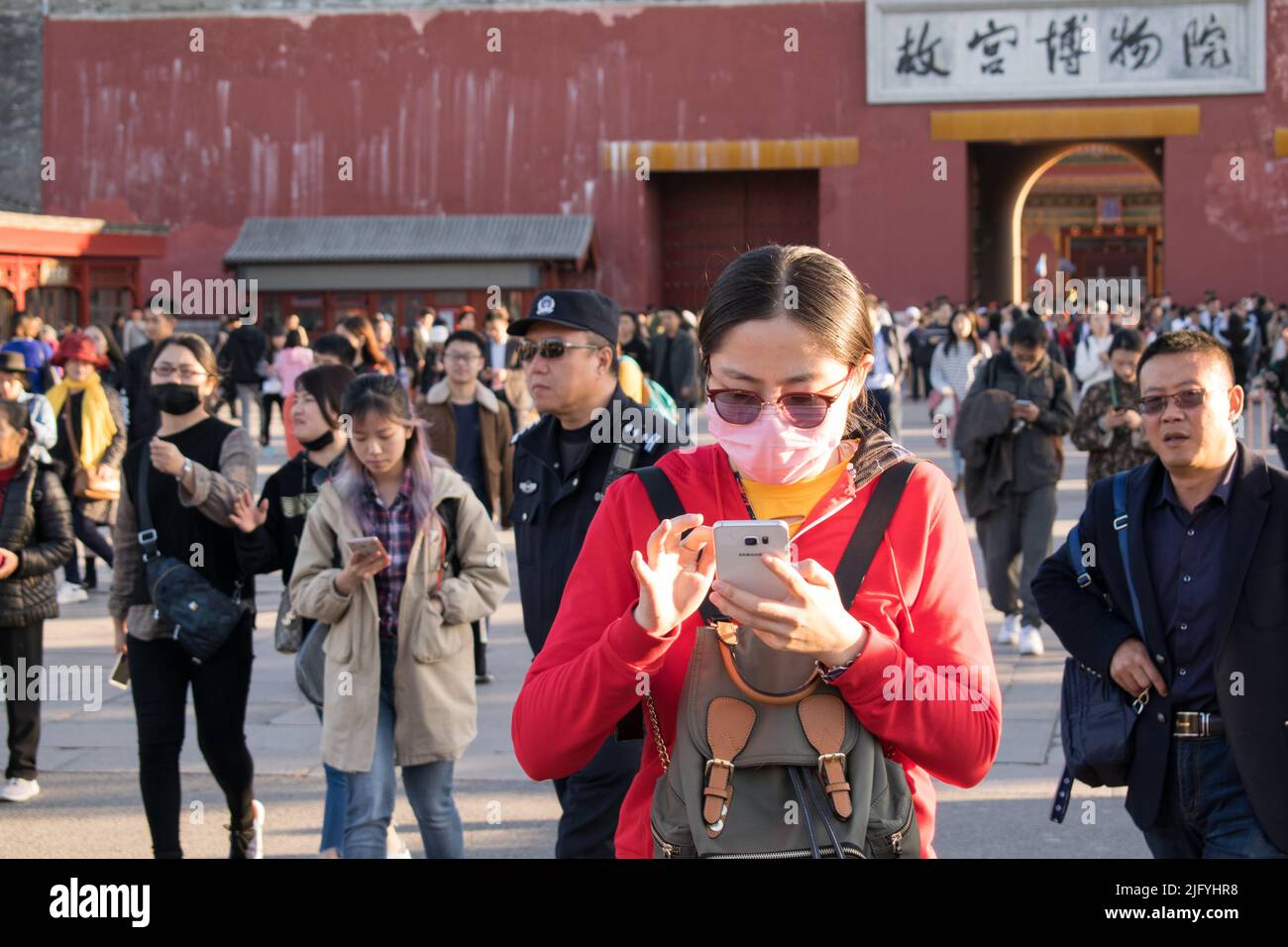 A Young Chinese Woman Wearing A Face Mask Against Air Pollution And Her Backpack In Front Is 7991
